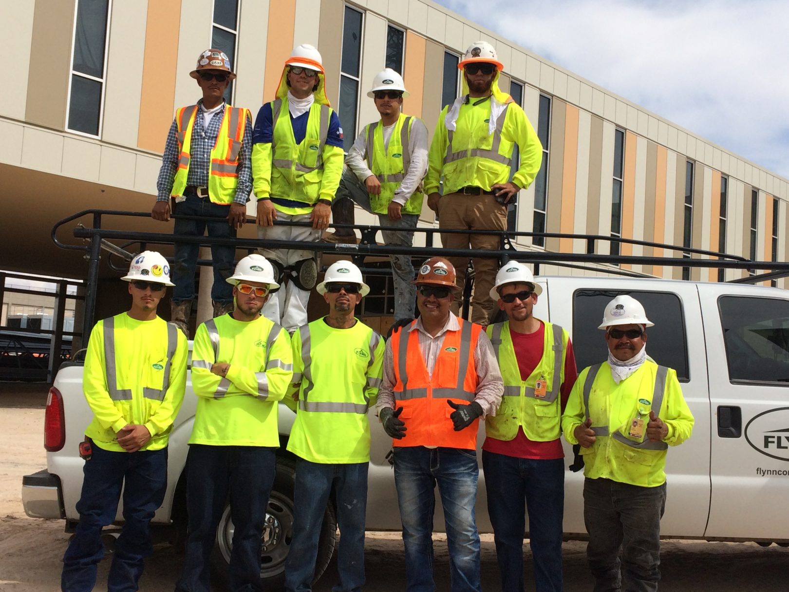 Flynn Crew photo in front of the Eastwood High School project