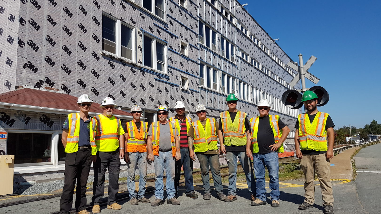 Flynn crew group photo in front of a new build project