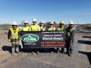 Flynn crew holding up a safety sign