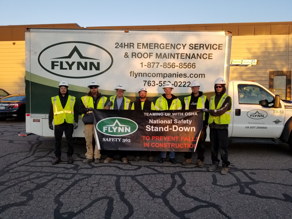 Flynn crew holding up a safety sign Minneapolis