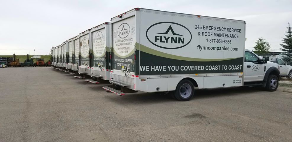 a line up of Flynn service trucks