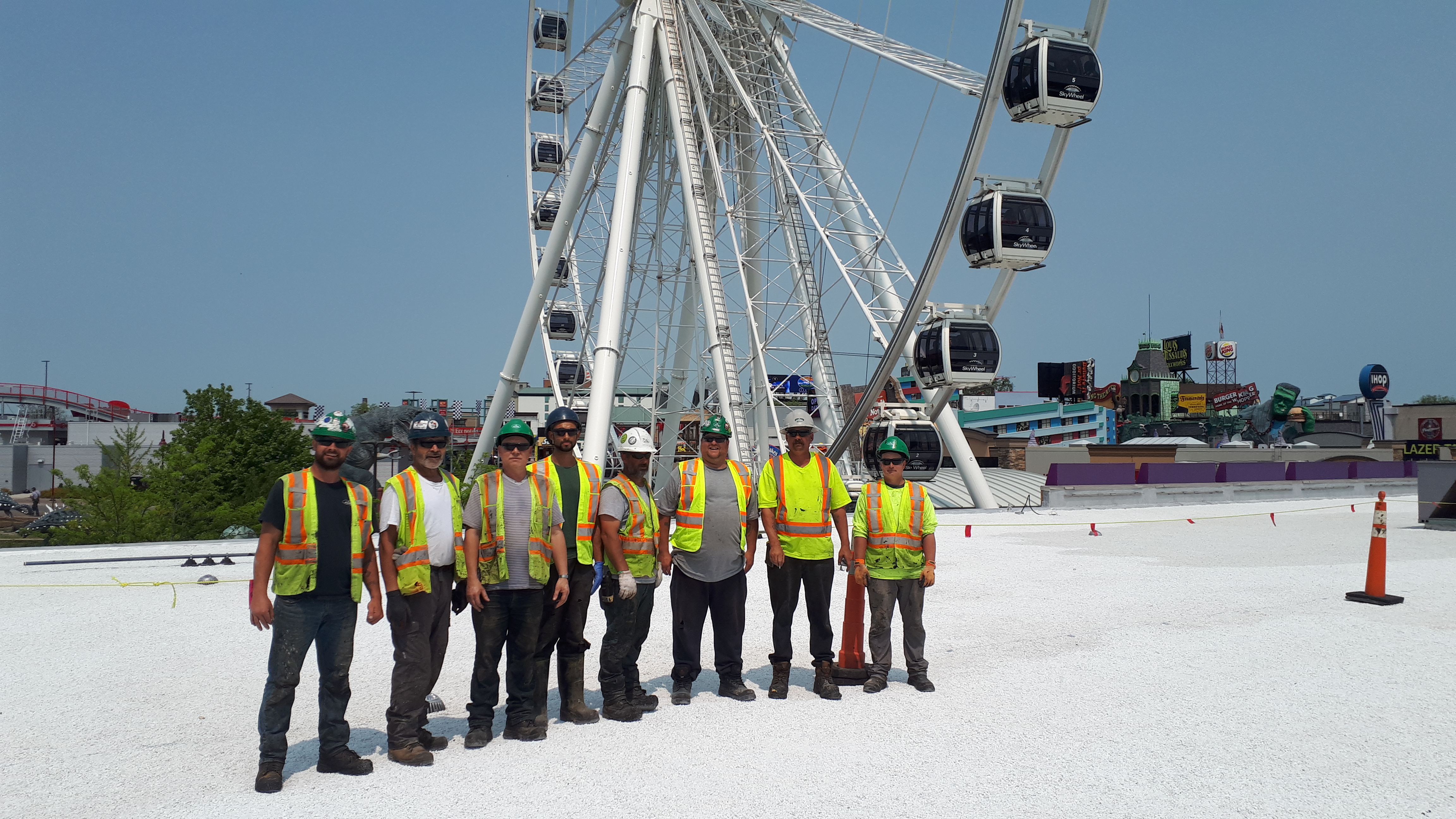 Construction workers in front of Ferris Wheel