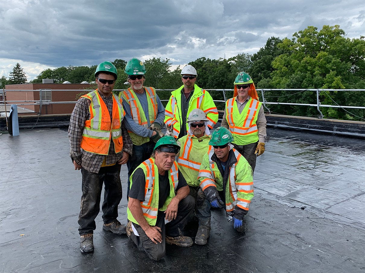 Seven construction workers on roof
