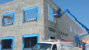 Construction worker installing window